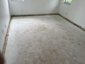 Before flooring installation project in delray beach Fl after carpet removal with exposed subfloor preparation